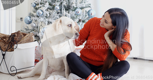 Image of Young woman and her dog celebrating Christmas