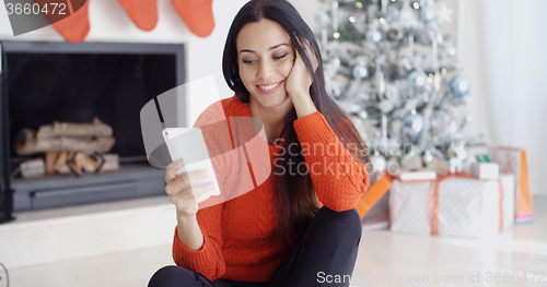 Image of Young woman checking out her text messages