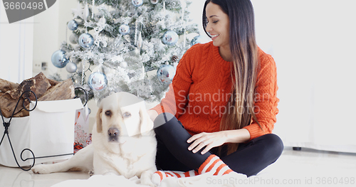 Image of Young woman and her dog celebrating Christmas