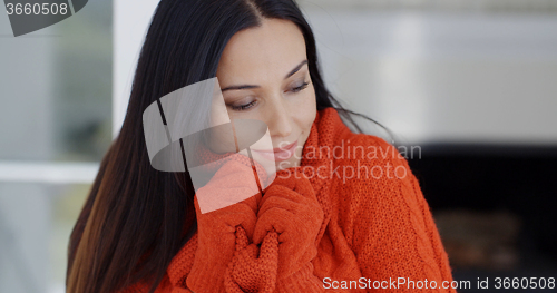 Image of Woman cuddling down in her warm winter fashion