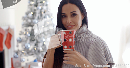 Image of Woman enjoying a cup of Christmas coffee