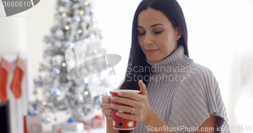 Image of Woman enjoying a cup of Christmas coffee