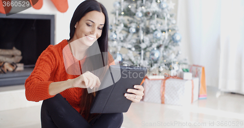 Image of Smiling woman catching up on her social media