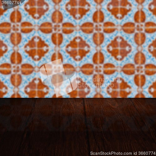 Image of Wood table top and blur vintage ceramic tile pattern wall