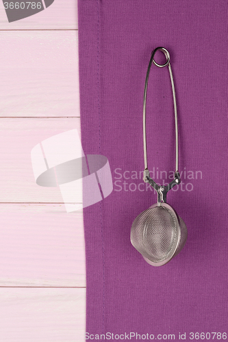 Image of Kitchenware on purple towel