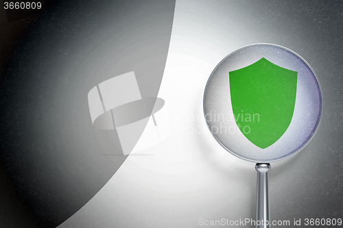 Image of Security concept:  Shield with optical glass on digital background