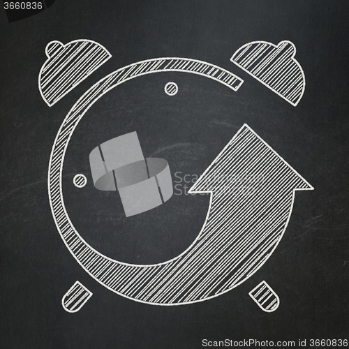 Image of Time concept: Alarm Clock on chalkboard background