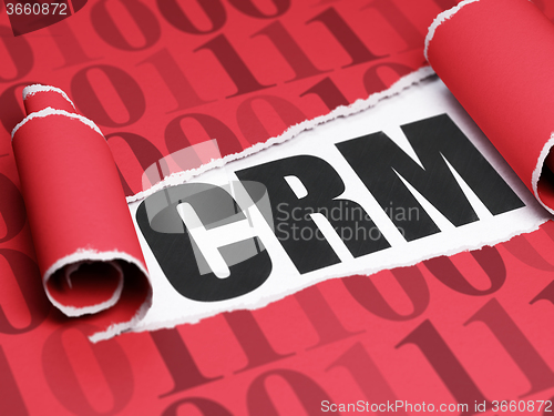 Image of Business concept: black text CRM under the piece of  torn paper
