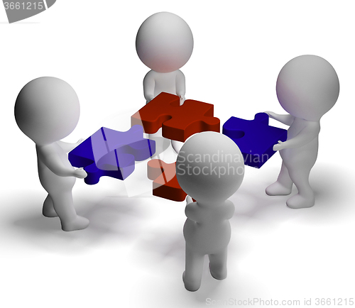 Image of Jigsaw Pieces Being Joined Showing Teamwork And Assembling