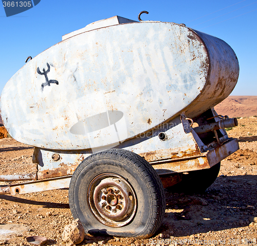 Image of water tank in morocco africa land gray  metal weel and arid