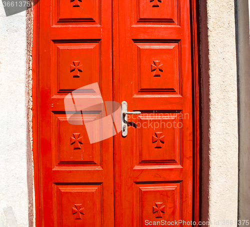 Image of white  red brown  door in antique village santorini greece europ