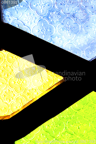Image of colorated glass and sun in   window and light