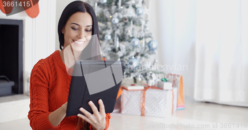 Image of Smiling woman catching up on her social media