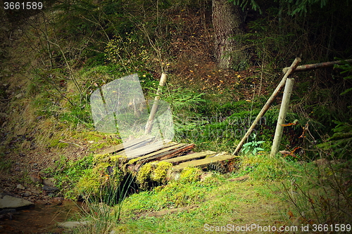 Image of small damaged wooden bridge