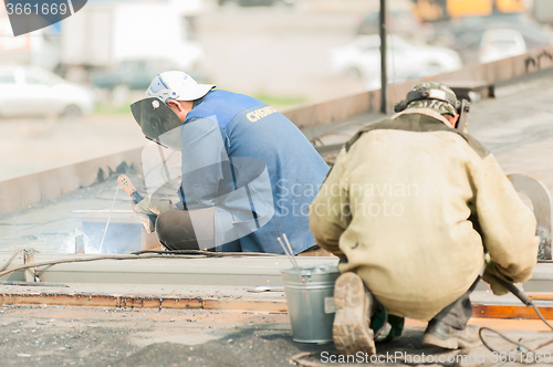 Image of industrial worker welders during working process