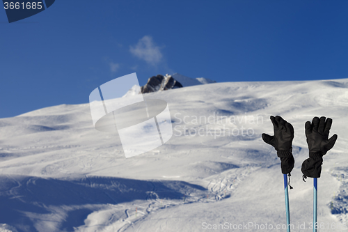 Image of Gloves on ski poles at ski resort