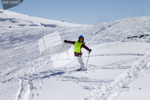 Image of Little skier on ski slope with new fallen snow at sun day