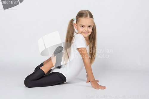 Image of Girl gymnast performs an exercise fish