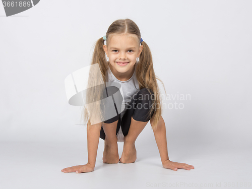 Image of An aspiring gymnast performs a warm toes