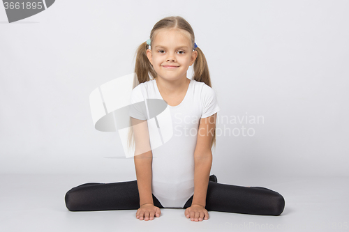 Image of Girl gymnast performs exercises Frog