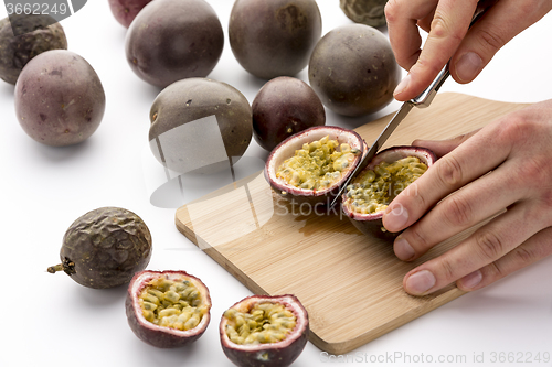 Image of Halving Passion Fruits With A Kitchen Knife