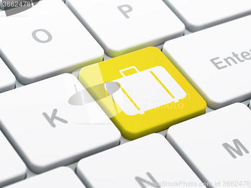 Image of Tourism concept: Bag on computer keyboard background