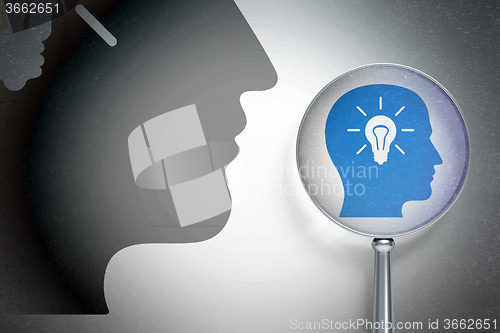Image of Studying concept:  Head With Light Bulb with optical glass on digital background
