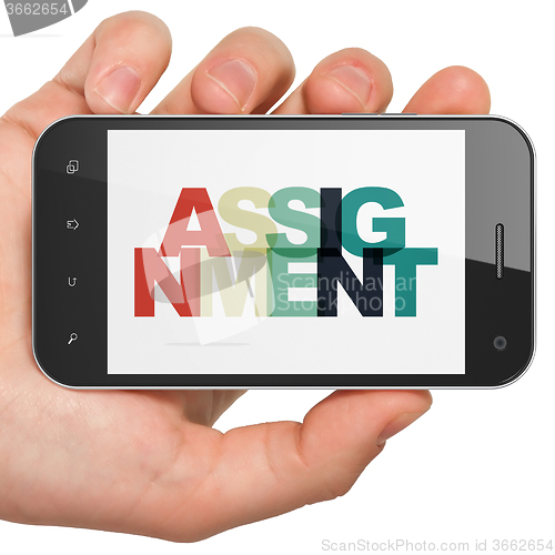Image of Law concept: Hand Holding Smartphone with Assignment on  display