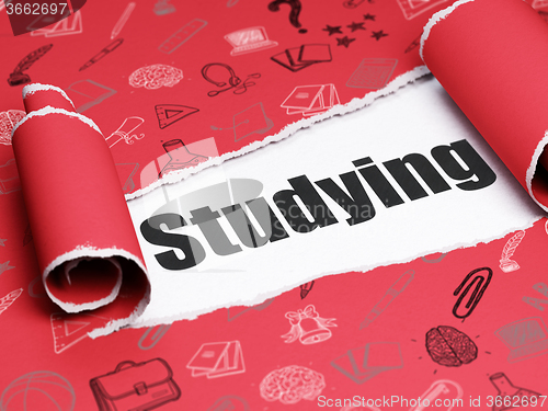 Image of Education concept: black text Studying under the piece of  torn paper