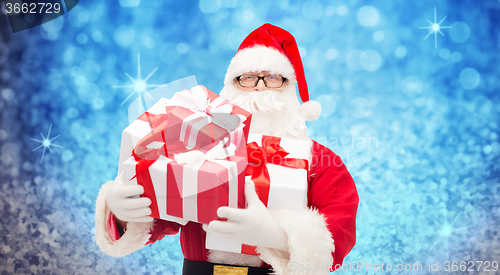 Image of man in costume of santa claus with gift boxes