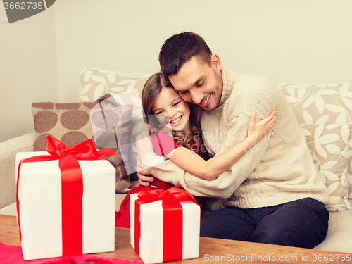 Image of smiling father and daughter hugging