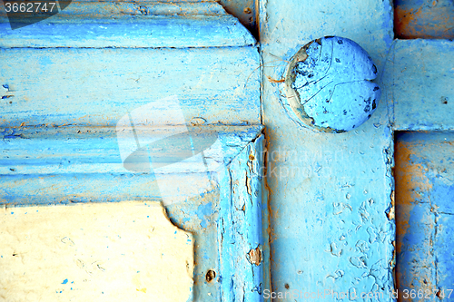 Image of rusty metal      stripped paint in the  and morocco knocker