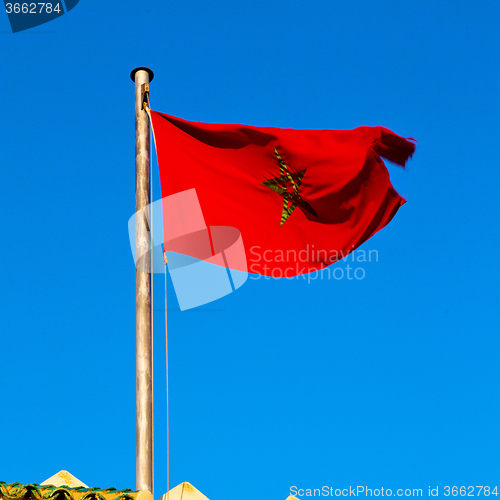 Image of tunisia  waving flag in the blue sky  colour and battlements  wa