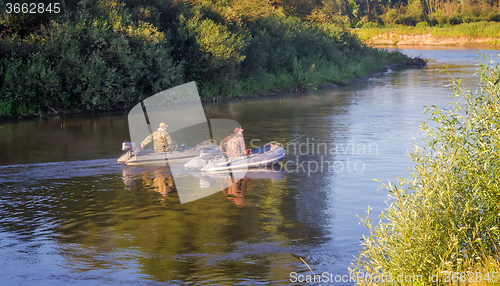 Image of Fishermen on the river float boat