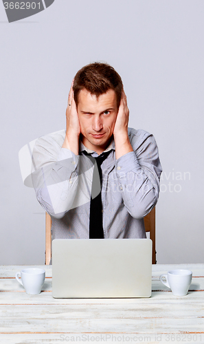 Image of man working on laptop in the office