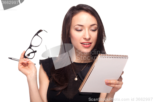 Image of Young office worker in glasses with notebook