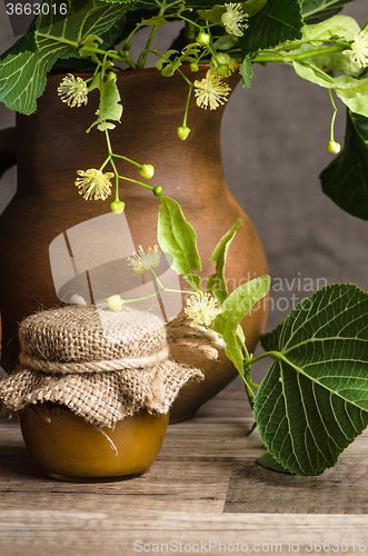 Image of Jar with lime honey on a table, Close up