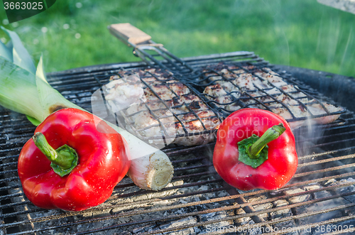 Image of Cooking meat and vegetables on the grill