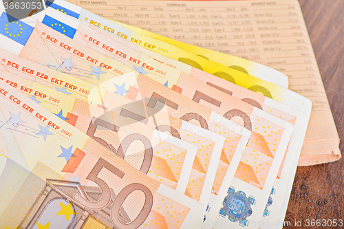 Image of Close-up of Euro banknotes with newspaper