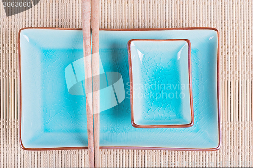 Image of Top view to bamboo mat, dish and chopsticks