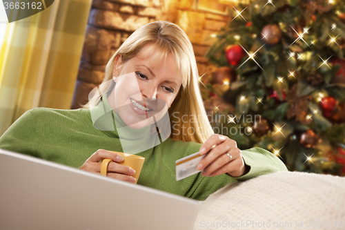 Image of Woman with Credit Card In Front of Laptop, Christmas Tree