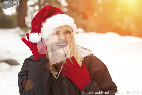 Image of Attractive Santa Hat Wearing Blond Woman Having Fun in Snow