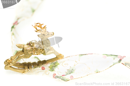 Image of Decorative Christmas Reindeer Ornament and Ribbon on White