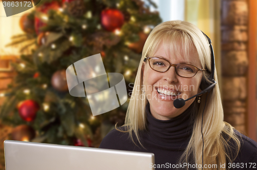 Image of Woman with Phone Headset In Front of Christmas Tree, Computer