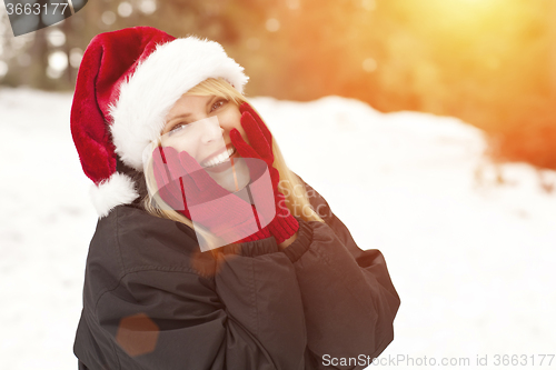 Image of Attractive Santa Hat Wearing Blond Woman Having Fun in Snow