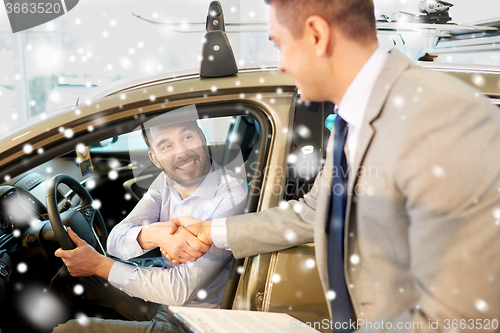 Image of happy man with car dealer in auto show or salon