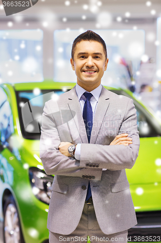 Image of happy man at auto show or car salon