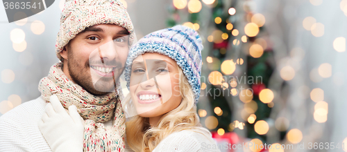 Image of smiling couple in winter clothes hugging