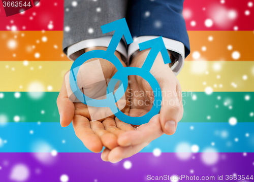 Image of close up of happy male gay couple with love symbol