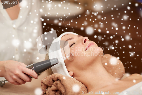 Image of close up of young woman having face massage in spa